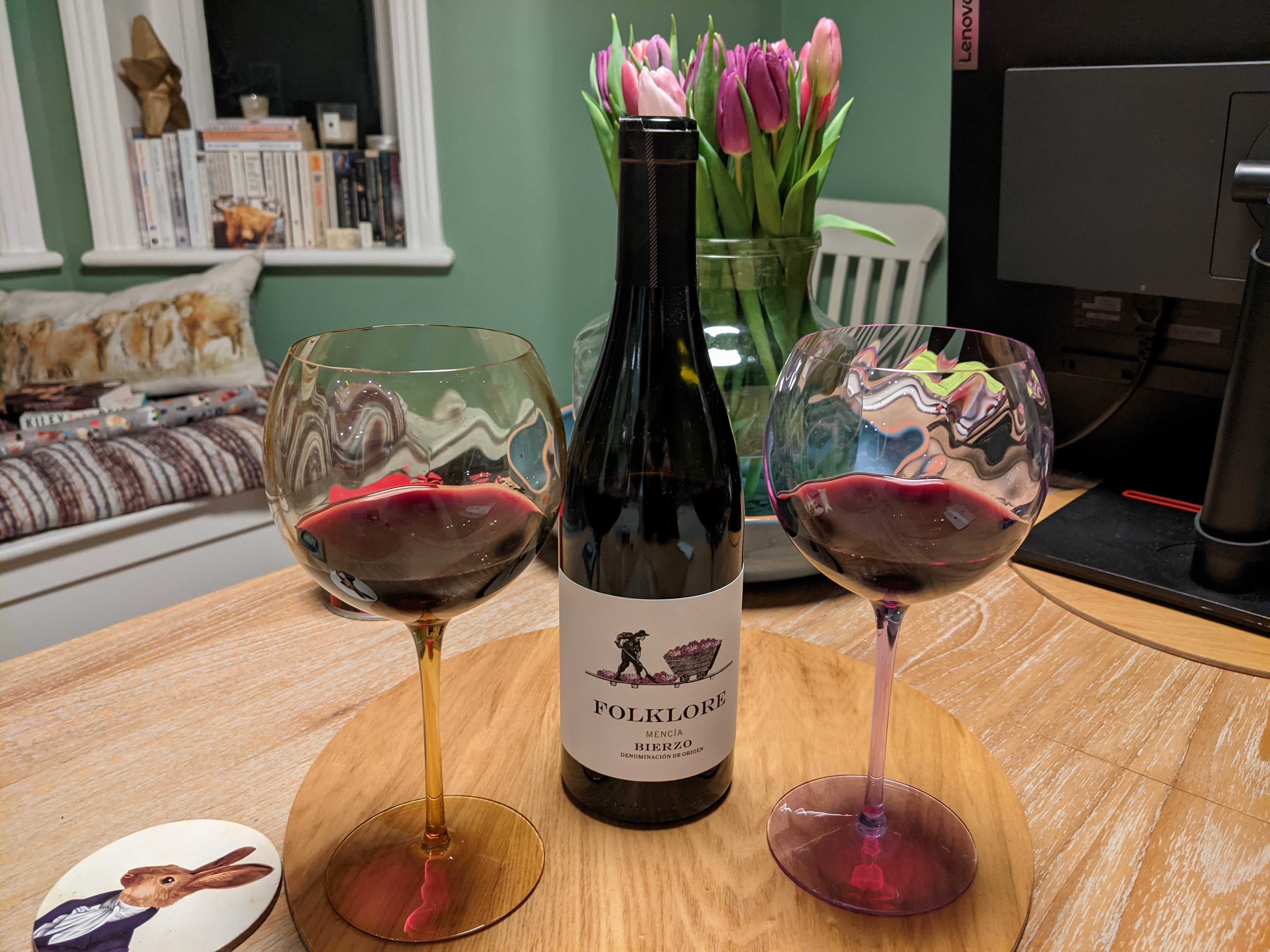 Photograph of a couple of glasses of "Folklore" wine, along with the bottle